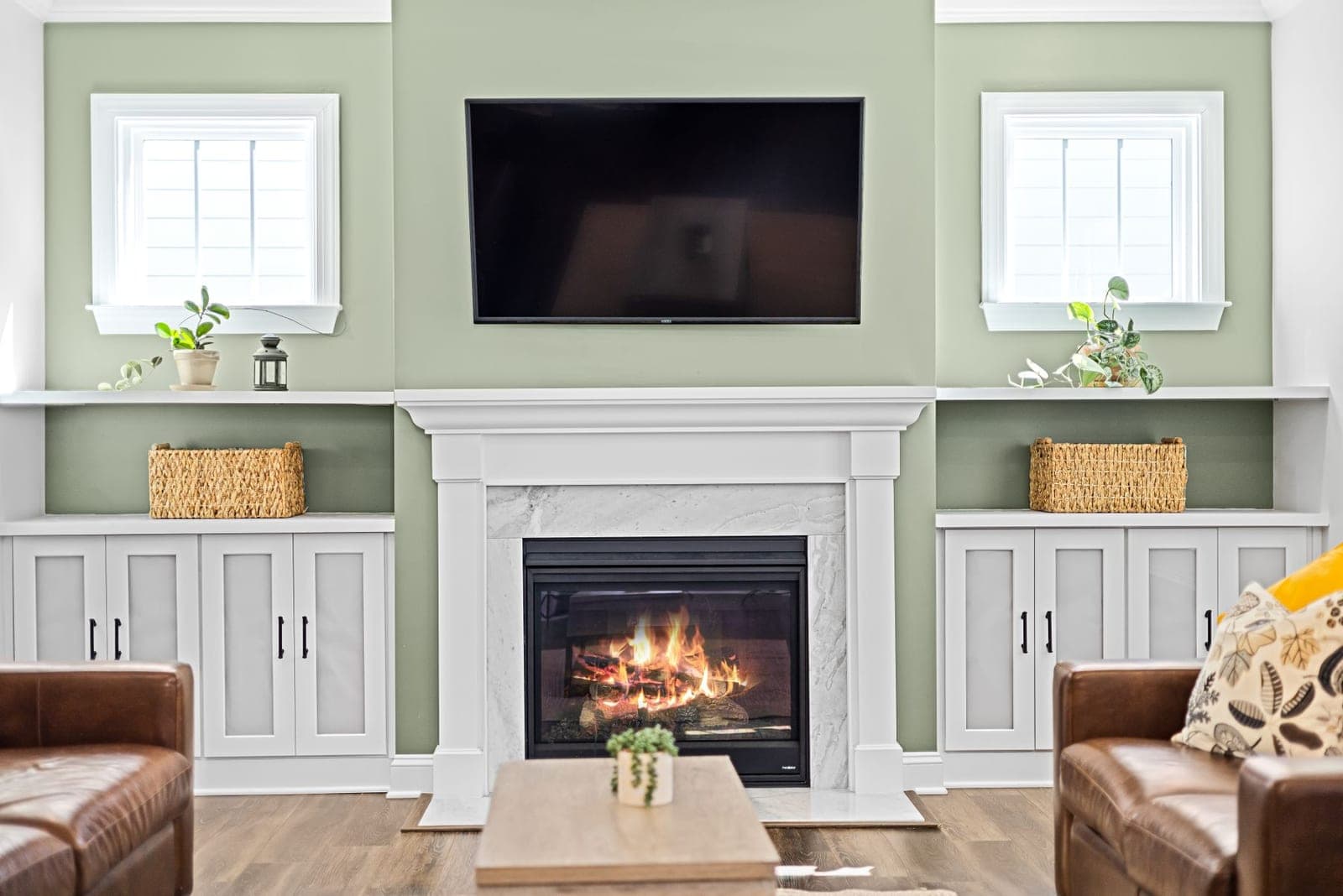 TV mounted above a white fireplace mantel with a soundbar